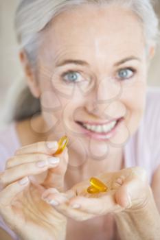 Royalty Free Photo of a Woman Taking Capsules