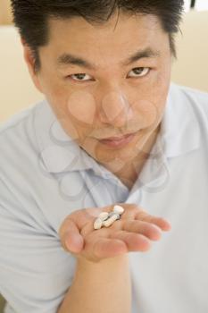 Royalty Free Photo of a Man Taking Pills