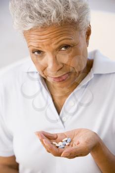 Royalty Free Photo of a Woman Taking Pills