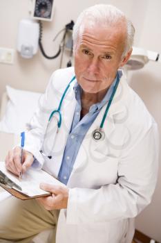 Royalty Free Photo of a Middle-Aged Doctor With a Clipboard