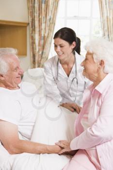 Royalty Free Photo of a Doctor With a Patient and His Wife