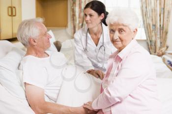 Royalty Free Photo of a Doctor With a Patient and His Wife