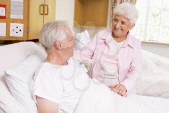 Royalty Free Photo of a Woman Visiting Her Husband in the Hospital