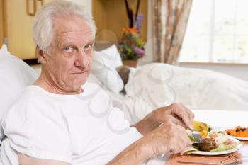 Royalty Free Photo of a Man Eating in the Hospital