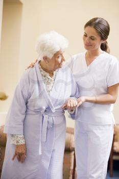 Royalty Free Photo of a Nurse Helping a Female Patient