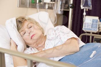 Royalty Free Photo of a Woman Asleep in a Hospital Bed
