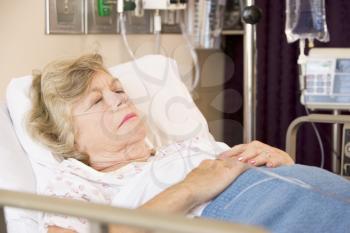 Royalty Free Photo of a Woman Sleeping in a Hospital Bed