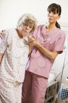 Royalty Free Photo of a Nurse Helping a Patient Walk