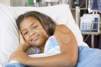 Royalty Free Photo of a Young Girl in a Hospital Bed
