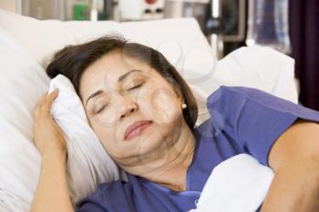 Royalty Free Photo of a Woman Asleep in a Hospital Bed