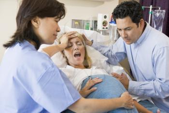 Royalty Free Photo of a Woman Giving Birth