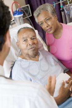 Royalty Free Photo of a Senior Couple Talking to a Doctor