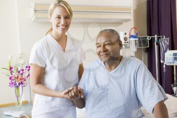 Royalty Free Photo of a Nurse Helping a Patient