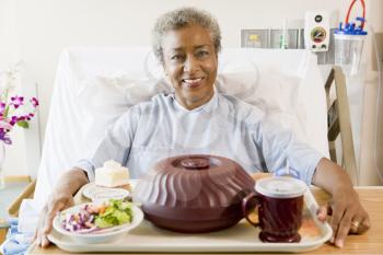 Royalty Free Photo of a Woman With a Tray of Food in the Hospital