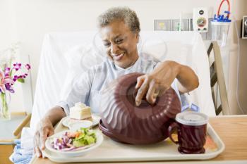 Royalty Free Photo of a Woman in the Hospital With Food