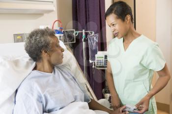 Royalty Free Photo of a Nurse Talking to a Woman