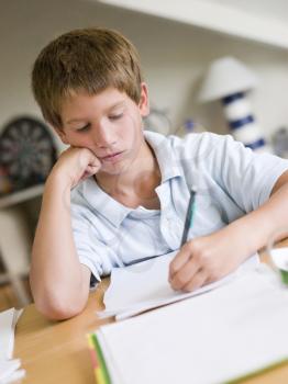 Royalty Free Photo of a Boy Doing Homework in His Room