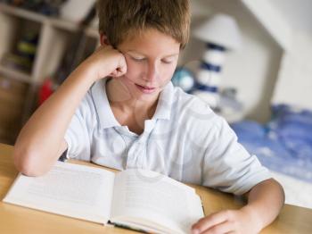 Royalty Free Photo of a Boy Reading a Book