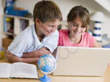 Royalty Free Photo of a Boy and Girl Doing Homework on a Laptop