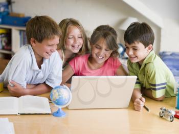 Royalty Free Photo of a Group of Children Doing Homework on a Laptop