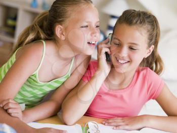 Royalty Free Photo of Two Girls Talking on a Cellphone