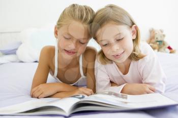 Royalty Free Photo of Young Girls Reading a Book
