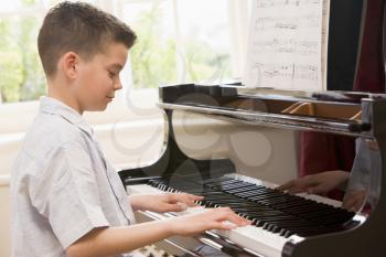 Royalty Free Photo of a Boy Playing Piano