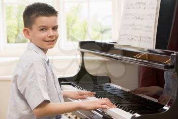 Royalty Free Photo of a Boy Playing Piano