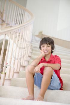 Royalty Free Photo of a Little Boy Sitting on the Stairs