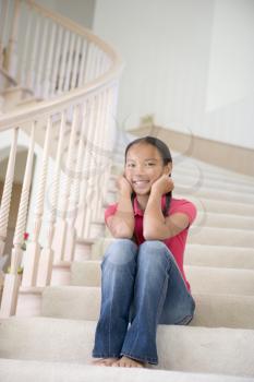 Royalty Free Photo of a Girl Sitting on the Stairs