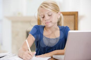 Royalty Free Photo of a Girl With a Laptop Doing Homework