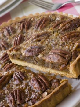 Royalty Free Photo of a Slice Being Taken From a Pecan Pie