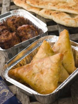 Royalty Free Photo of Indian Take Away- Vegetable Samosa, Naan Bread And Onion Bahji