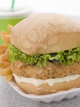 Royalty Free Photo of a Southern Fried Chicken Fillet Burger With Fries And A Soft Drink