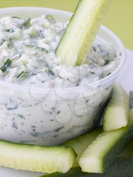 Royalty Free Photo of a Cucumber Dipped In Tzatziki