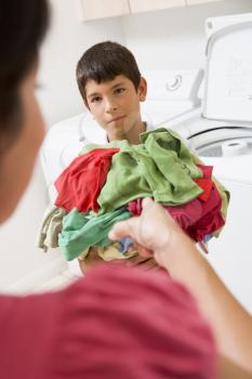 Royalty Free Photo of a Boy Doing Laundry