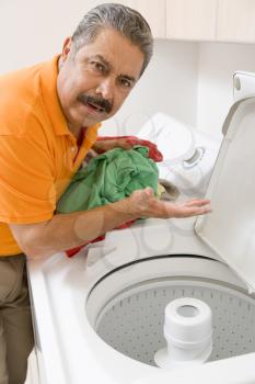 Royalty Free Photo of a Man Doing Laundry