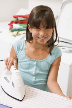 Royalty Free Photo of a Little Girl Ironing