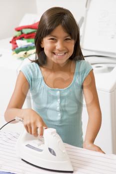 Royalty Free Photo of a Girl Ironing