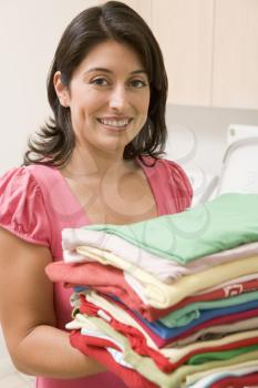 Royalty Free Photo of a Woman Holding Fresh Laundry