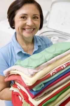 Royalty Free Photo of a Woman With Folded Laundry