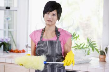 Royalty Free Photo of a Woman With a Feather Duster