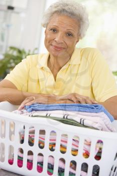 Royalty Free Photo of a Woman Leaning on a Wash Basket