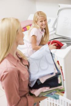 Royalty Free Photo of a Mother and Daughter Doing Laundry