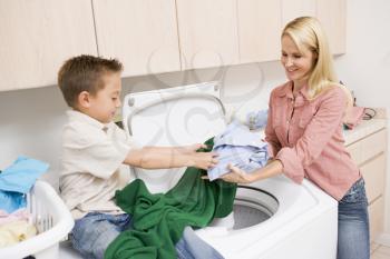 Royalty Free Photo of a Mother and Son Doing Laundry