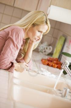 Royalty Free Photo of a Woman at a Kitchen Counter