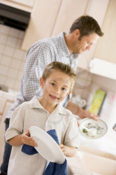 Royalty Free Photo of a Father and Son Doing Dishes