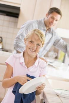 Royalty Free Photo of a Father and Daughter Doing Dishes