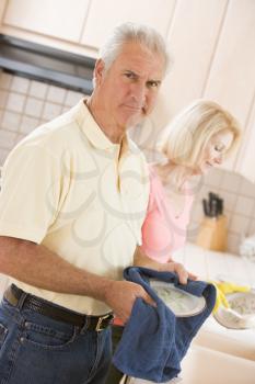 Royalty Free Photo of a Husband and Wife Doing Dishes