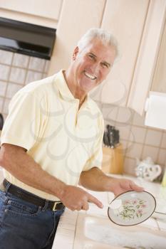 Royalty Free Photo of a Man Doing Dishes